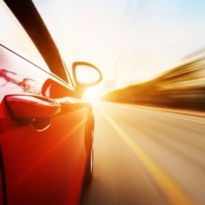 Car driving in sunset